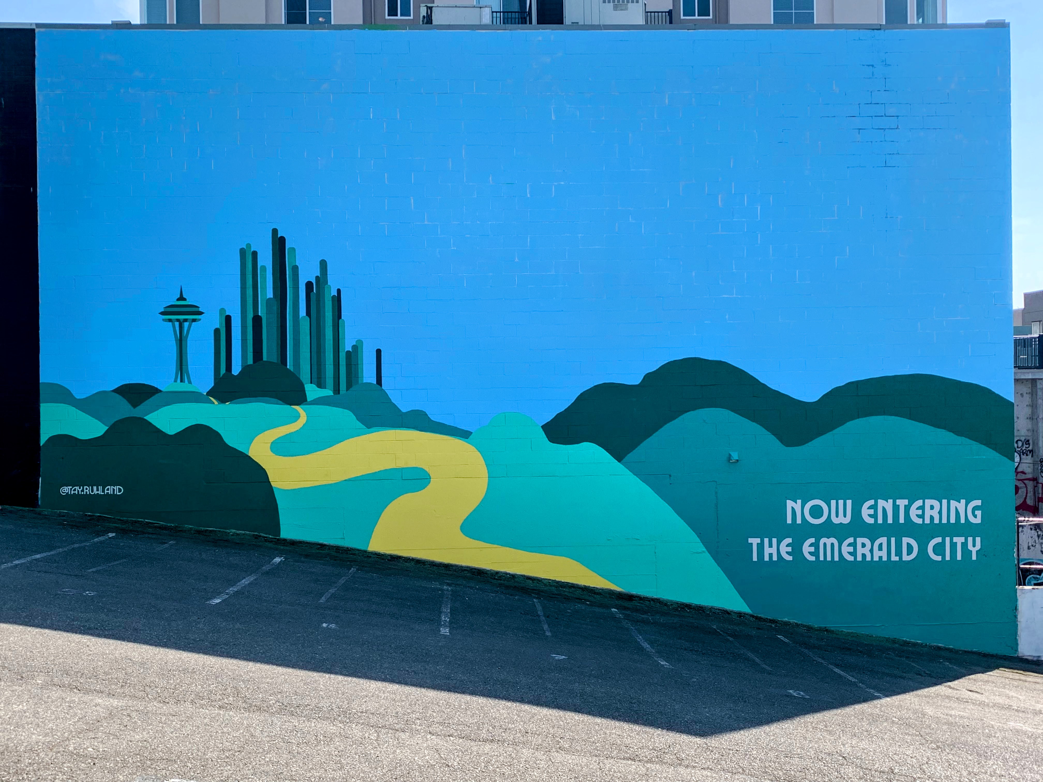 Emerald City mural in Seattle's Uptown neighborhood featuring vibrant green cityscape